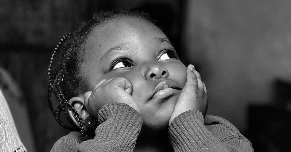 A child looking bored and disengaged during a learning session, illustrating common reasons children struggle with Quran classes.
