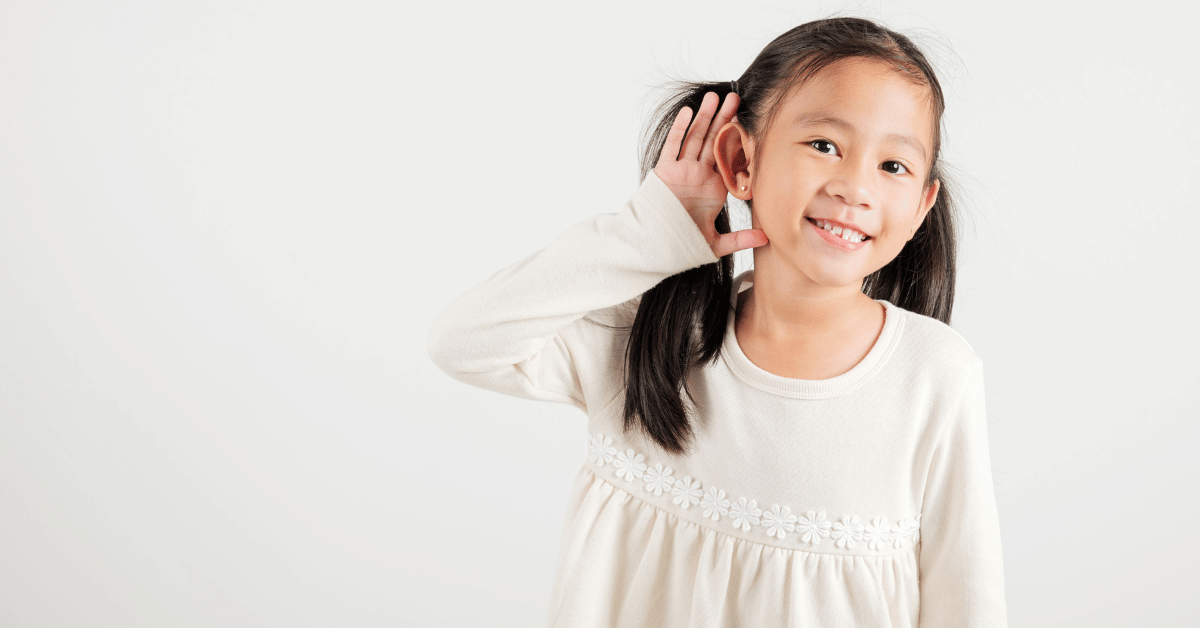 A young girl holding her hand to her ear, representing how children struggle to understand Quran teachers who speak unclear English or unfamiliar accents.