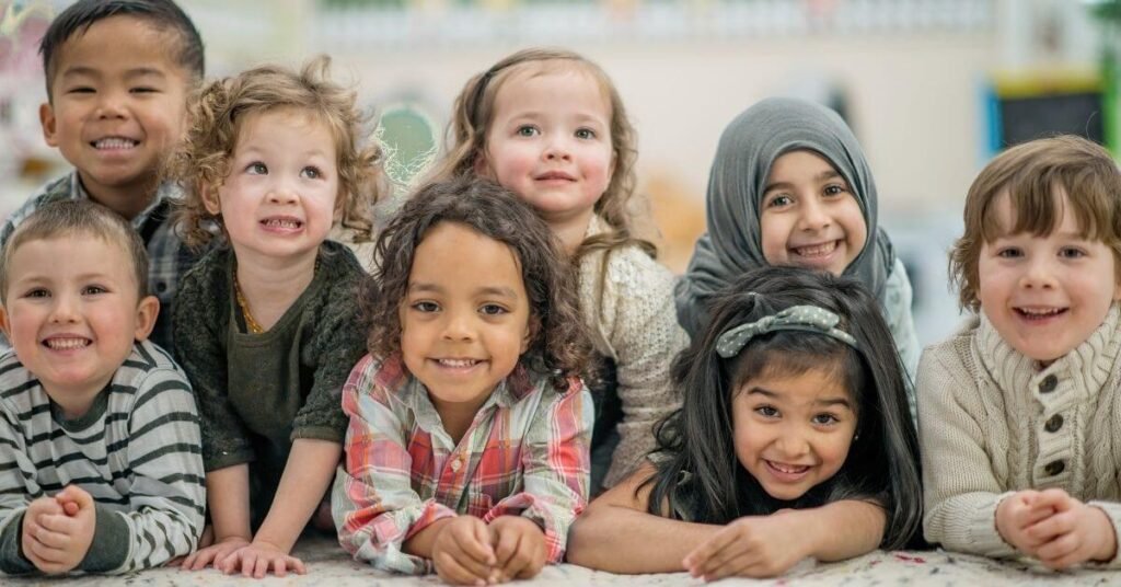 Kids of different ethnicities smiling together, representing diversity in online Quran learning