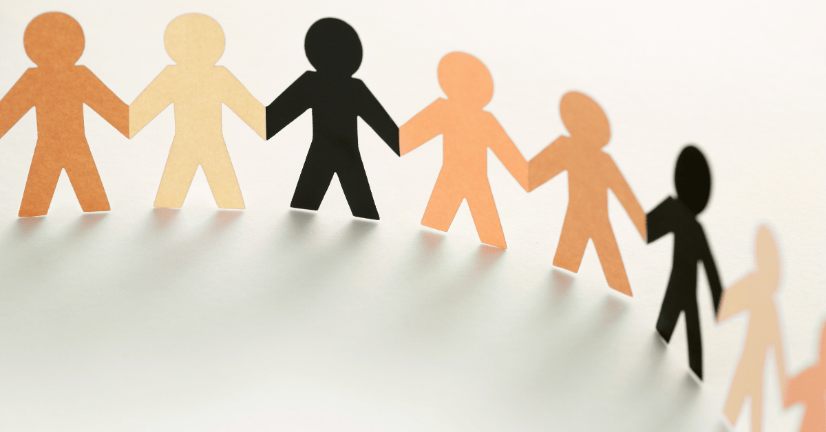 Paper cutout figures of different skin tones holding hands, symbolizing unity and diversity in online Quran tutoring.