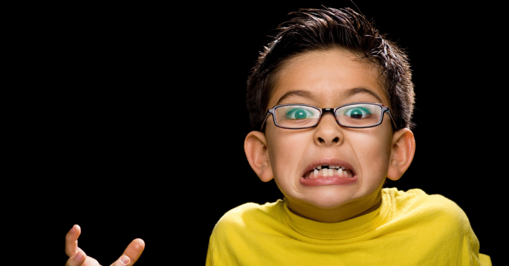 A confused child wearing glasses expressing frustration while learning Quran recitation and Tajweed rules