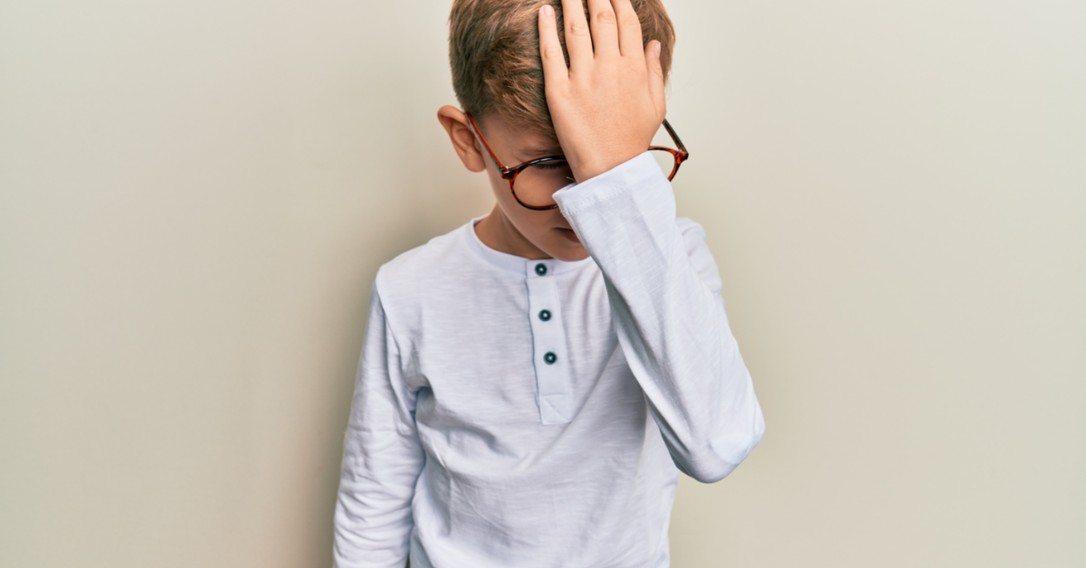 A young child looking confused while practicing Quran recitation, representing difficulty remembering Tajweed rules