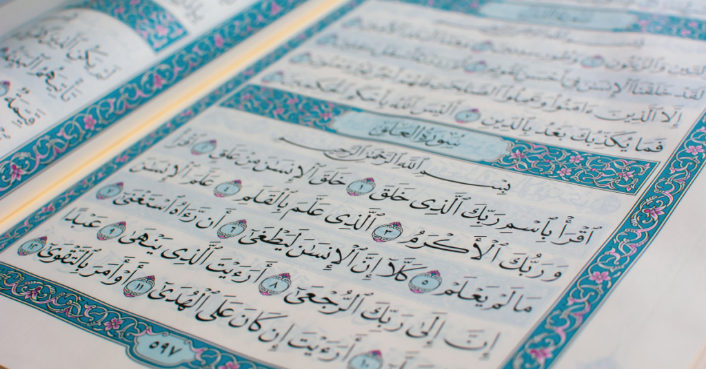 Open Quran page with Arabic verses used for teaching correct Quran pronunciation and Tajweed to students